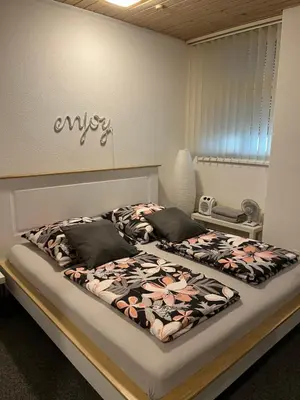 a bedroom with two beds with flowers on them at Guest room David 11 in St. Gallen