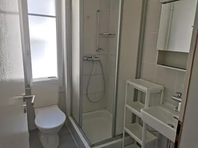 a bathroom with a shower and a toilet and a sink at City Home St Gallen in St. Gallen