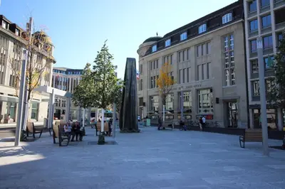 a city square with benches and buildings in a city at Casa Schilling 2,5 rooms in St Gallen, modern, quiet and close to the center in St. Gallen