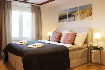 a bedroom with a bed with two towels on it at Completely renovated apartment near the train station and the center in St. Gallen