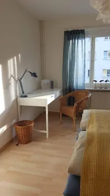 a living room with a desk and a table at Casa Schilling- 2,5 rooms with balcony near hospital, university in St. Gallen