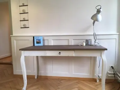 a white desk with a lamp on top of it at Casa Schilling - 4 charming rooms in the best location in St. Gallen
