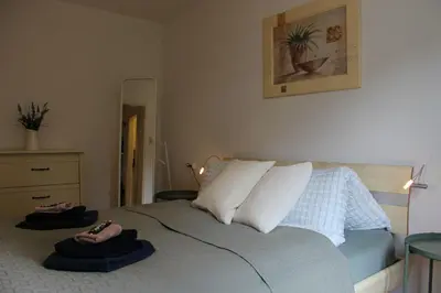 a bedroom with a bed with two towels on it at Nice apartment with sun terrace in St. Gallen