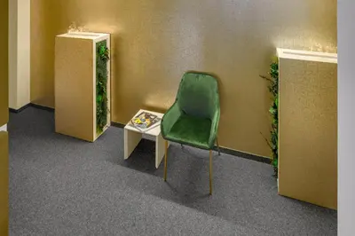a green chair and a table in a room at VISIMO Apartments Steigerstrasse St Gallen - Modern Living near OLMA & Hospital in St. Gallen