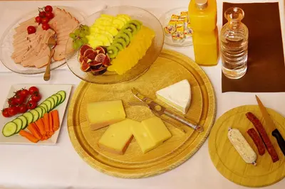a table with two plates of cheese and other foods at Hotel Garni Arnegg in Arnegg