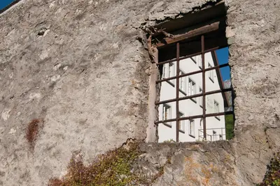 a window in the side of a stone building at Hotel Restaurant Schlössli Sax in Sax