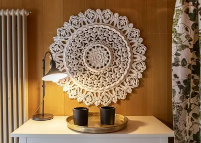 a table with a lamp and a plate on a wall at Capanna in Wildhaus