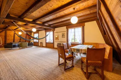 a dining room with a table and chairs in a room at Schloessli Herrenhof in Herrenhof