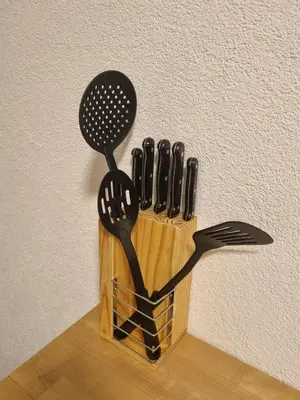 a knife and fork holder with utensils on a wall at 24-7 Rooms in Sennwald