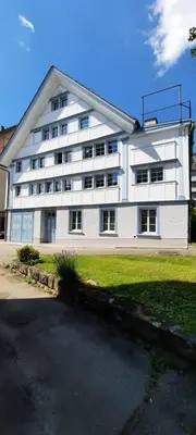 a large white building with a lot of windows at Vreni`s Ferienwohnung in Gais