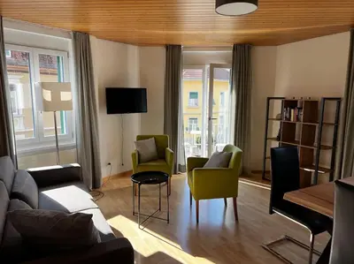 a living room with a couch and chairs at Charmante und zentrale Wohnung am Weiherpark Arbon in Arbon
