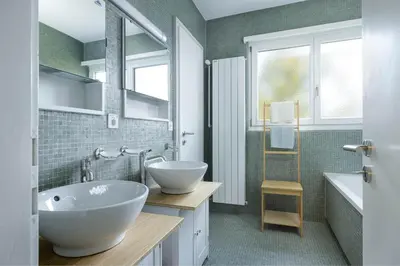 a bathroom with a large white tub and a sink at Luxury apartment with terrace and garden free parking smart TV etc in St. Gallen
