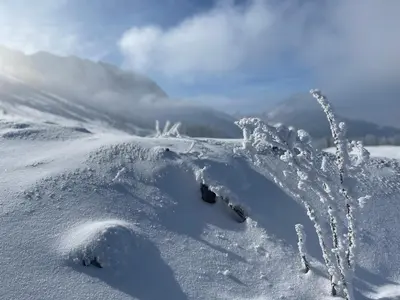 a mound of snow with a mountain in the background at Blässchopfhüsli in Nesslau