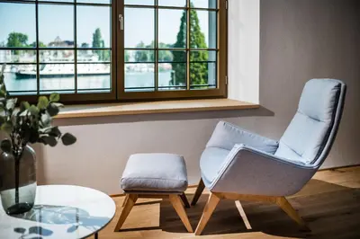 two chairs and a table in a room with a window at Business Appartement 1 am Bodensee in Romanshorn