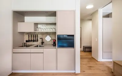 a kitchen with white cabinets and a sink at Business Appartement 1 am Bodensee in Romanshorn