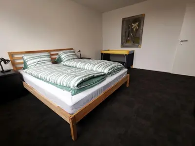a bed with green pillows on it in a room at Ferienwohnung Hirschen in Gossau