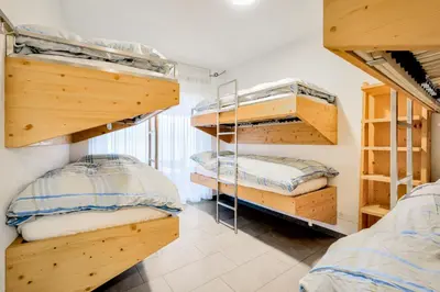 a room with three bunk beds in a room at Hotel Restaurant Berghaus Malbun Buchserberg in Buchs