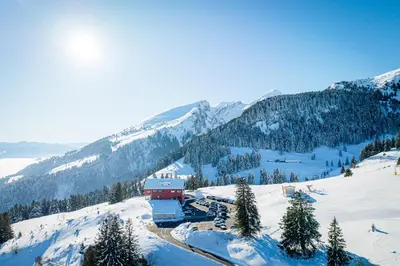 a building on top of a snow covered mountain at Hotel Restaurant Berghaus Malbun Buchserberg in Buchs