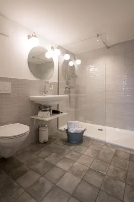 a bathroom with a toilet and a sink and a tub at JACOB 1808. fine historic town apartments in Bischofszell