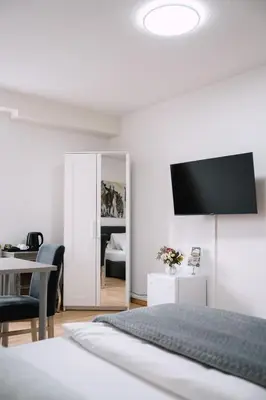 a bedroom with a bed and a tv on the wall at Hotel & Restaurant Nollen in Hosenruck