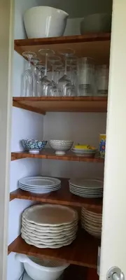 a pantry with plates and bowls on shelves at Ferienwohnung Florida in Stein